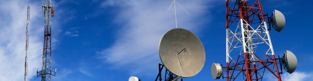 Several kind of communication antennas and a red and white tower